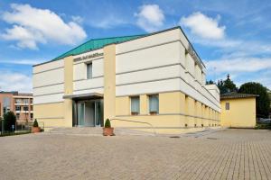 a white and yellow building with a green roof at Best Western Hotel San Marco in Siena +16 photos