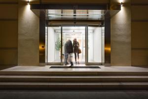 two people walking through a door in a building at Best Western Hotel San Marco in Siena