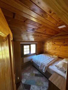 a bedroom with a bed in a wooden cabin at Ayder Villa Bravo in Çamlıhemşin +23 photos