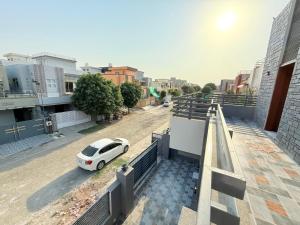 a white car parked on the side of a street at House No 6, Valley Homes in Pothi