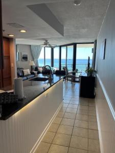 a living room with a view of the ocean at Beachfront Condo Panama City Beach Gulf Front Views walk to Pineapple Willy's in Panama City Beach +29 photos