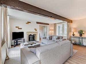 a living room with white furniture and a fireplace at 5 Bed in Halifax oc-96061 in Sowerby Bridge