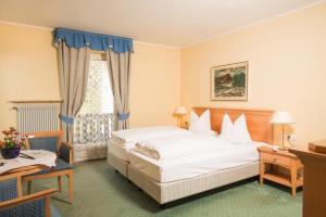 A bed or beds in a room at Hotel Regina