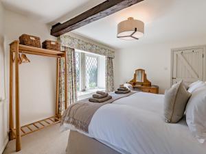 a bedroom with a large white bed and a window at 5 Bed in Halifax oc-96061 in Sowerby Bridge