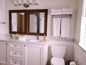 a bathroom with a toilet and a sink and a mirror at The Lindon House in Lindon +63 photos