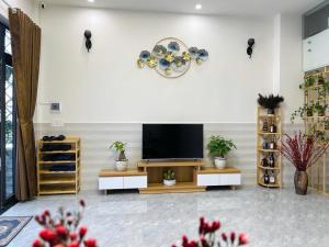 a living room with a flat screen tv on a wall at La Maison DaLat Home in Ấp Kim Thạch