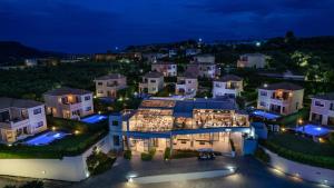 an aerial view of a mansion at night at St John Villas Zakynthos in Tsilivi
