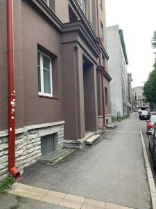 an empty street next to a brown building at Peaceful Room in Shared Flat Close to Old Town in Tallinn