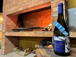 a bottle of wine sitting next to a brick oven at Complejo La Mística in Copacabana