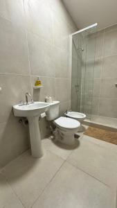 a bathroom with a sink and a toilet and a shower at Complejo La Mística in Copacabana +34 photos