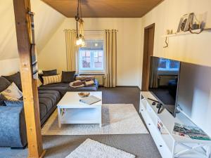 a living room with a couch and a tv at Apartment Graugans by Interhome in Freiburg - Elbe