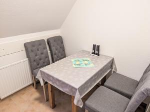 a table and two chairs in a room at Apartment Graugans by Interhome in Freiburg - Elbe