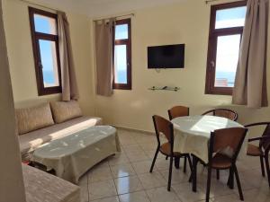 a living room with a couch and a table and chairs at Terre d'Océan in Taghazout