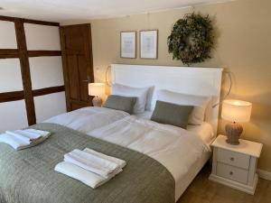 a bedroom with a large white bed with two pillows at Ferienwohnung Schultheiß in Remptendorf +42 photos
