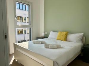 a white bed in a room with a window at Bressanone Apartments in Milan