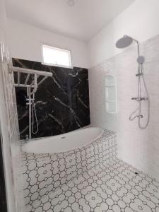 a bathroom with a bath tub and a window at Harmony Villa in Wok Tum +9 photos