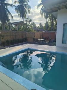 a swimming pool with a reflection in the water at Harmony Villa in Wok Tum