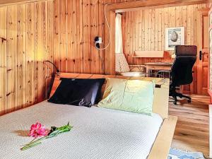 a bedroom with a bed with a flower on it at Chalet Chalet chemin du four by Interhome in Morgins