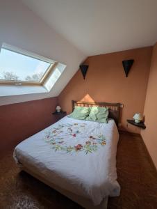a bedroom with a large bed with a window at Chambres des Gatinelles in Erbray +11 photos