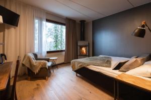 ein Schlafzimmer mit einem großen Bett und einem Kamin in der Unterkunft Santa's Hotel Aurora & Igloos in Luosto