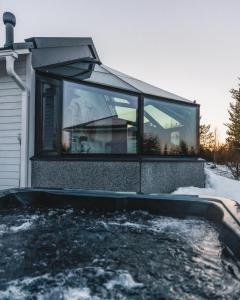 a house with a window on the side of it at Santa's Igloos Arctic Circle in Rovaniemi