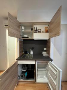 a small kitchen with a sink and a counter at Studio Climatisé au centre ville in Digoin +4 photos