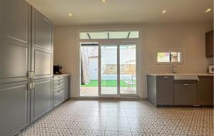 a kitchen with a door open to a patio at Convent Holiday Home in Petra