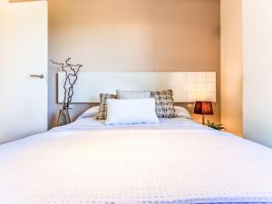 a bedroom with a bed with a white bedspread at Studio Justina by Interhome in L'Ampolla