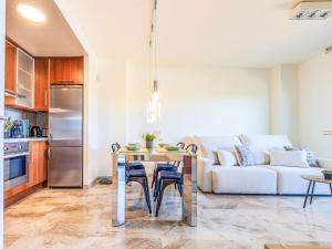 a kitchen and living room with a table and a couch at Studio Justina by Interhome in L'Ampolla