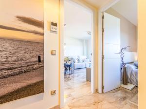 a room with a door open to a bedroom with a view of the ocean at Studio Justina by Interhome in L'Ampolla