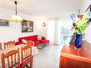 a living room with a red couch and a table at Apartment Sa Guilla by Interhome in Pals