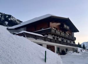 a large building with snow in front of it at Appartements Birkenhof in Lech am Arlberg