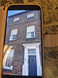 a brick building with a blue door and windows at 8 River view in King's Lynn