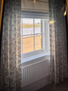 a window in a room with a view of the ocean at 8 River view in King's Lynn +5 photos