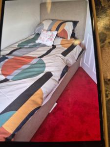 a bed with a comforter and pillows on it at 8 River view in King's Lynn