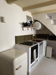 a small kitchen with a sink and a refrigerator at Casa Cookie in Ojén +11 photos