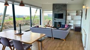 a living room with a couch and a table at Jog Lodge 8 By Together Travel - 3 Bed in John O Groats +14 photos