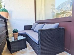 a living room with a wicker couch and a table at Apartment Grubhof by Interhome in Scheffsnoth
