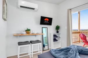 a bedroom with a table and a balcony at The Container Retreat - 2B in Canyon Lake