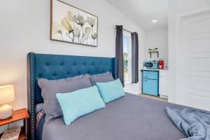 a bedroom with a blue bed with blue pillows at The Container Retreat - 2B in Canyon Lake