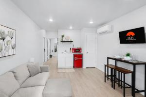 a white living room with a couch and a table at The Container Retreat - 2A in Canyon Lake +11 photos