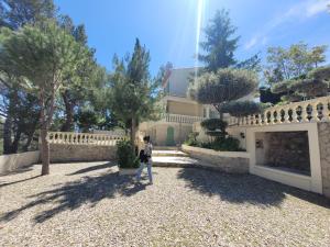 a man walking in front of a house at Villa Palama in Marseille