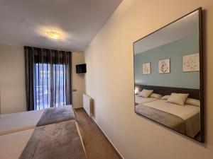a bedroom with a large mirror on the wall at Casa Polaco in Valderrobres