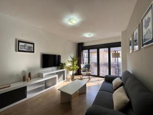 a living room with a couch and a tv at Casa Polaco in Valderrobres