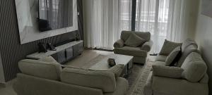 a living room with two couches and a tv at Easy stays baobab in Mombasa