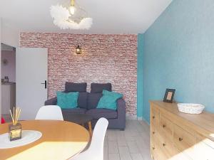 a living room with a couch and a table at Apartment U Centru by Interhome in Porto-Vecchio