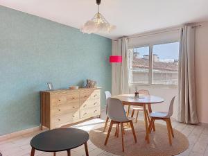 a dining room with a table and chairs and a dresser at Apartment U Centru by Interhome in Porto-Vecchio