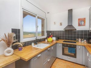 a kitchen with a sink and a window at Villa Can Gordei by Interhome in Albinyana
