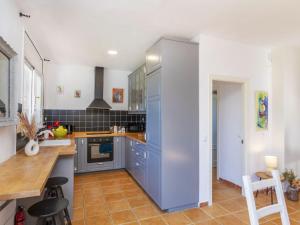 a kitchen with blue cabinets and a counter top at Villa Can Gordei by Interhome in Albinyana +20 photos