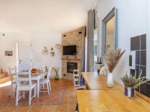 a kitchen and living room with a table and chairs at Villa Can Gordei by Interhome in Albinyana
